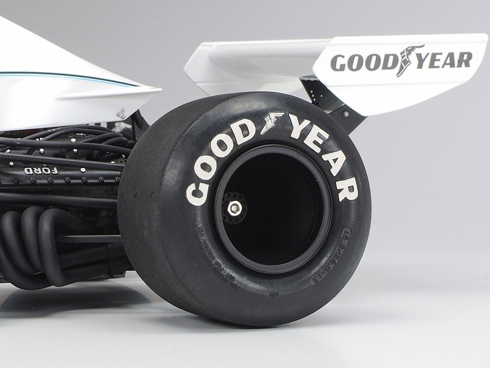 Semi-pneumatic synthetic rubber tires have molded Goodyear logos, which are painted white on the final model.